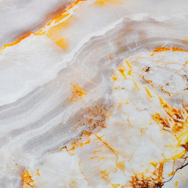 Detalle de tapete en tonos grises y naranjas con textura orgánica de mármol. All Star decoración