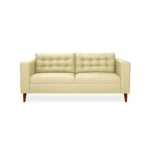 Sofá Honey 3 puestos tapizado en color beige con capitoneado, patas en madera maciza tono envejecido al 100% torneadas, visto desde frente. Muebles All Star