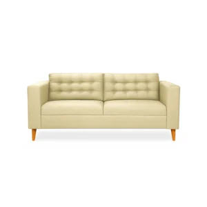 Sofá Honey 3 puestos tapizado en color beige con capitoneado, patas en madera maciza tono envejecido al 50% torneadas, visto desde frente.